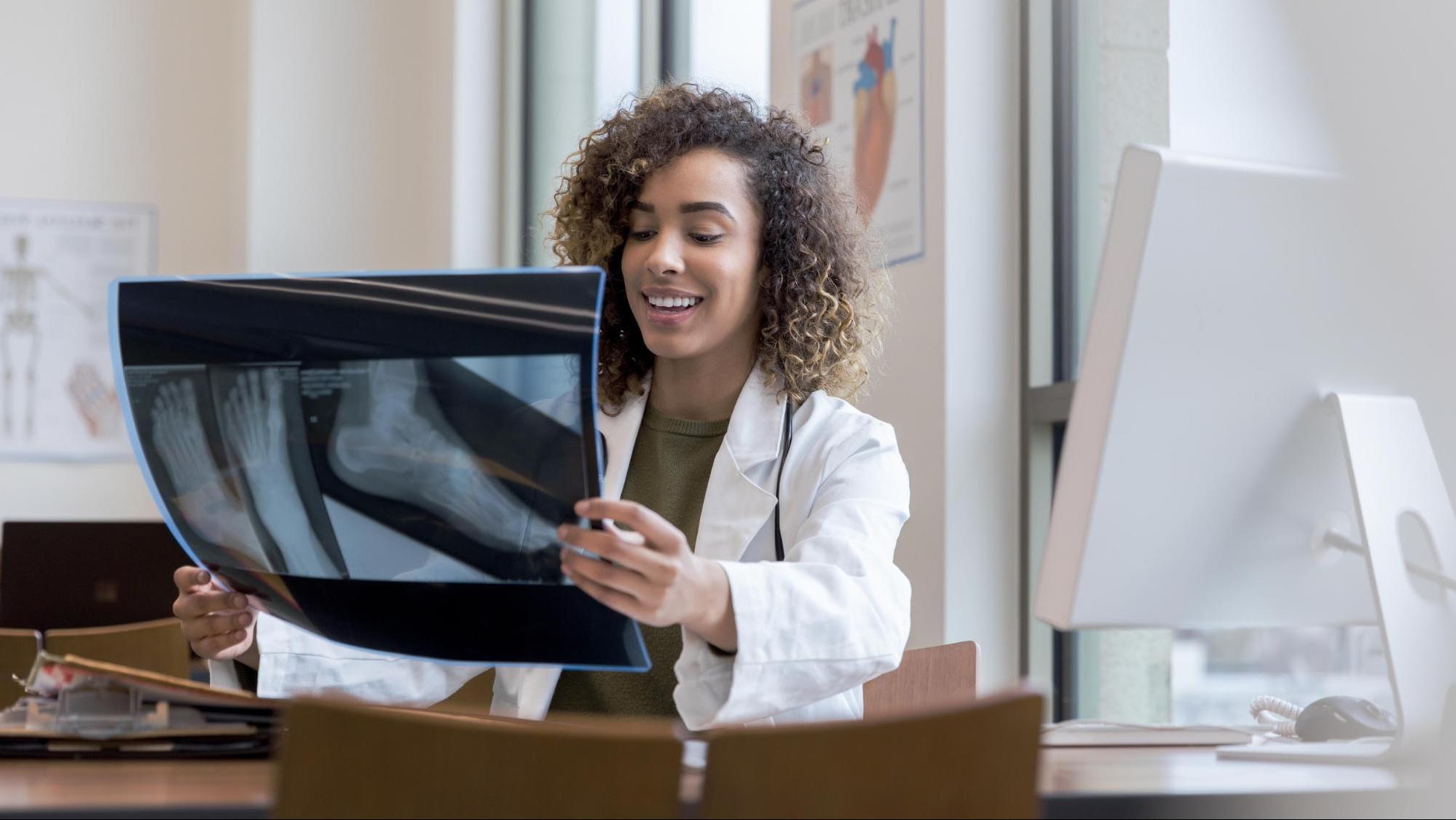 Podiatrist looking at x-ray of patient’s foot